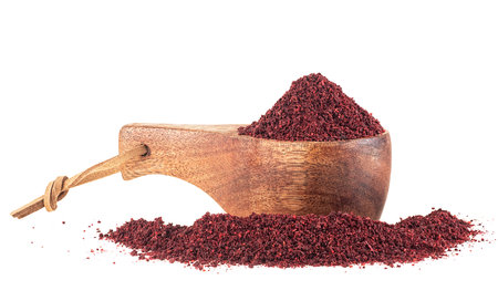 Ground sumac spice pile in wooden spoon isolated on a white backgroundの写真素材
