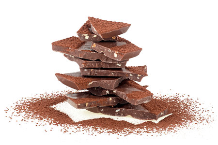 Pile of milk chocolate bar with cocoa powder isolated on a white background. Chocolate bars with chopped nuts.の写真素材
