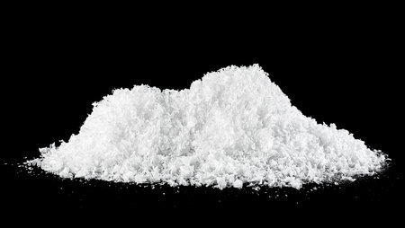 White snow at night. Snow pile isolated on a black background. Snowdrifts.の写真素材