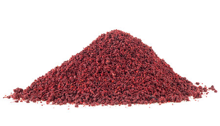 Ground sumac spice pile isolated on a white background. Dried ground red sumac powder.の写真素材