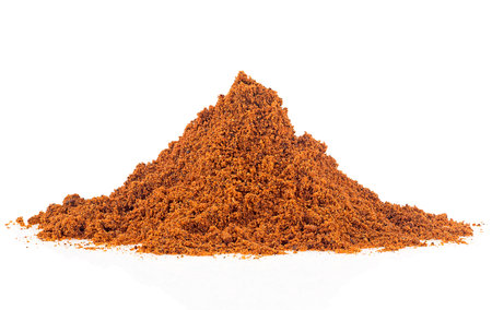 Pile of nutmeg powder isolated on a white background. Myristica fragrans.の写真素材