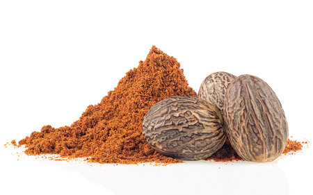 Dried seeds of fragrant nutmeg and gratified nutmeg isolated on a white backgroundの写真素材