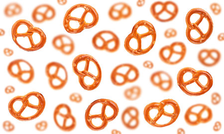 Falling salted pretzel crackers isolated on a white background. Flying baked snack.の写真素材