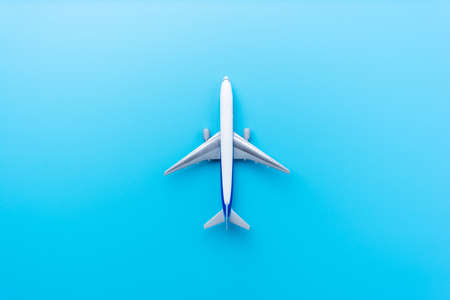 Top view of model airplane isolated on blue background for design mock upの写真素材