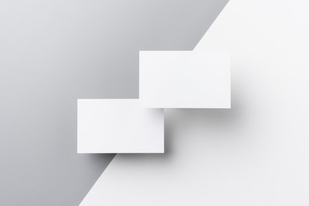 Top view of business card isolated on white and grey background for design mock upの写真素材
