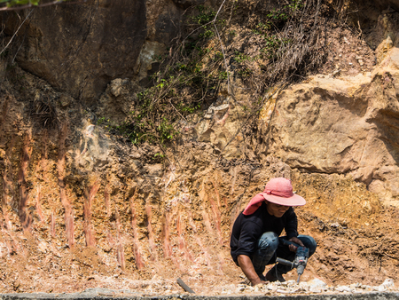man drilling a stone at the mountainのeditorial素材