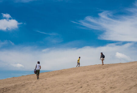 people walking at the desert and blue skyのeditorial素材