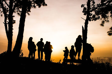 Silhouette of photographers on the moutain at sunriseの写真素材