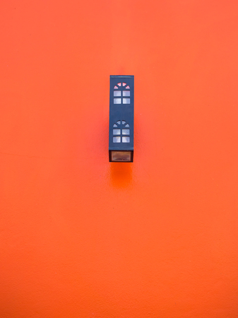 Black lamp with red wallの写真素材