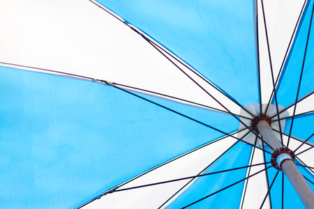 angle view of blue umbrella under sunshine, summer seasonの写真素材
