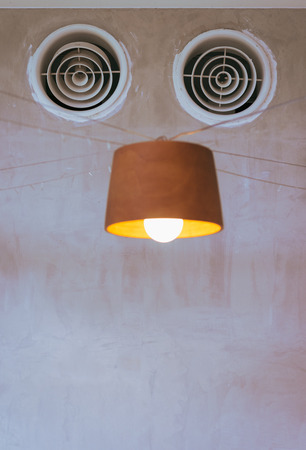 air ventilation on the wall and lamp look like robotの写真素材