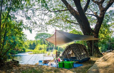 Camping and tent in nature park near the riverの写真素材