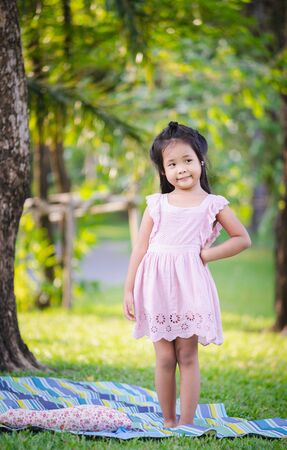portrait of cute little girl standing in the parkの写真素材