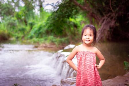 Portrait of little asian girl prepare to playing in nature water on holidayの写真素材