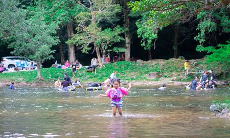 Nakhon Nayok, Thailandâ -â  October 27, 2018â: Little girl with pink rubber ring in nature water on holidayのeditorial素材