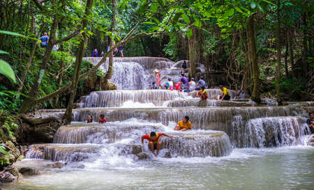 Kanchanaburi, Thailandâ -â July 28, 2019â: Tourists playing Huai Mae Khamin Waterfall to cool off in holidayのeditorial素材