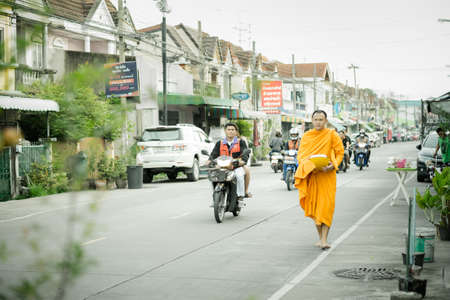 Samutprakan,Thailand - September 22, 2018 : Monk walking along road to alms round in the morningのeditorial素材
