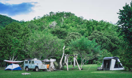 Camping and tent with mountain background in nature parkの写真素材