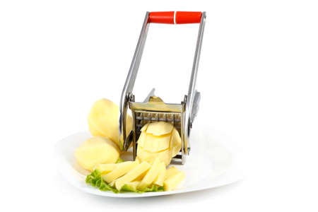 Raw peeled potatoes cut into a special machine at strawsの写真素材