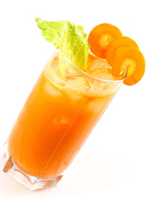 Freshly squeezed carrot juice is poured into a glass with iceの写真素材