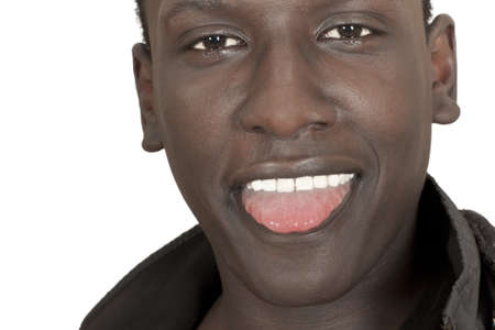 face of a young dark-skinned guy with his tongue hanging out isolated on white backgroundの写真素材