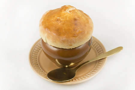 roast in a pot with the lid of the test close-up on white backgroundの写真素材