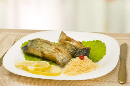pampanito fried fish on a plate with lemon