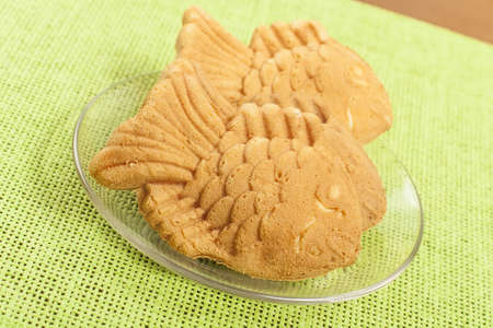 figure cookies in the shape of fish on a plate closeup