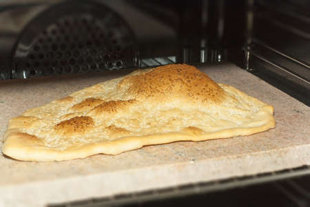 Eastern bread baking in oven on a stone