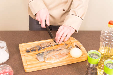 Cook ceramic knife cuts herring filletsの写真素材