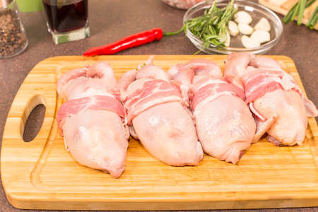 quails a whole bird and products for stuffing on the kitchen tableの写真素材