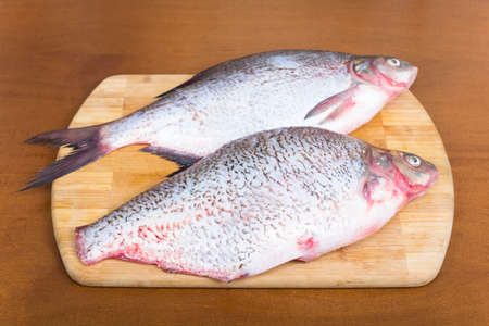 fresh peeled bream fish on a cutting board
