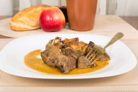 liver baked with apples in wine on a plateの写真素材