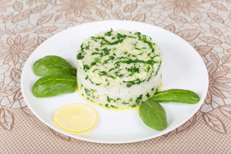 boiled rice with spinach molded using a pastry ringの写真素材