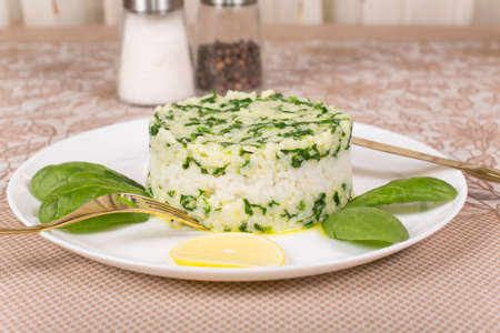 boiled rice with spinach molded using a pastry ringの写真素材
