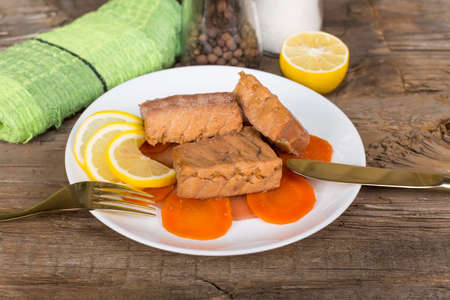 fish stew with vegetables on the old wooden tableの写真素材