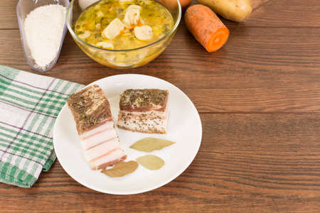 soup with dumplings and ham in a glass plate closeupの写真素材