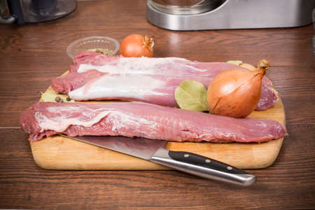 raw pork tenderloin on a cutting Boardの写真素材