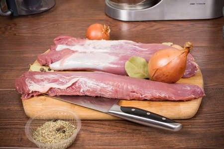 raw pork tenderloin on a cutting Boardの写真素材