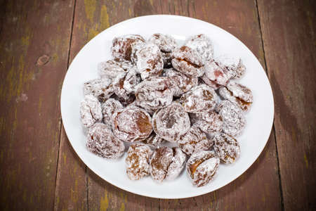 dried plum candied with sugar powderの写真素材