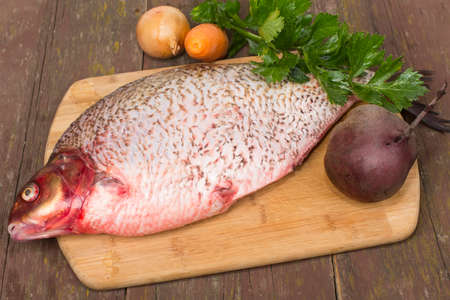 fish bream crude purified on a cutting Boardの写真素材