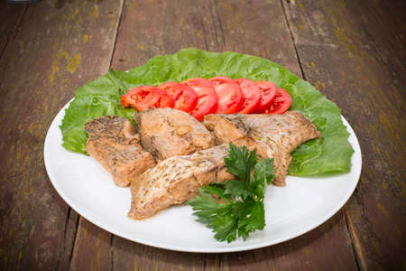 fish stew on the plate placed on the tableの写真素材