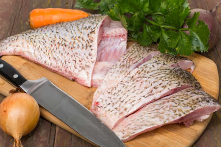 fish bream crude purified on a cutting Boardの写真素材