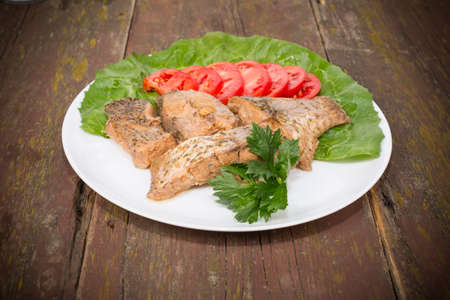fish stew on the plate placed on the tableの写真素材