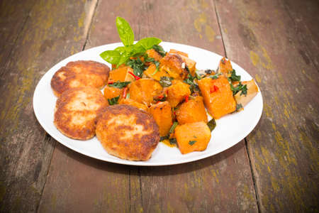 chicken cutlets baked with spices and pumpkinの写真素材