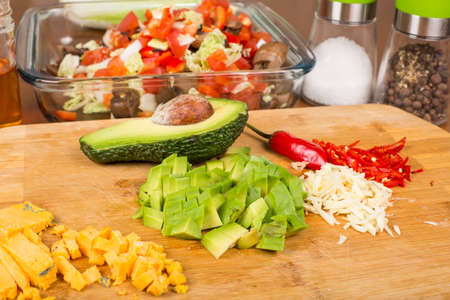 salad vegetables and ingredients sliced on a cutting board