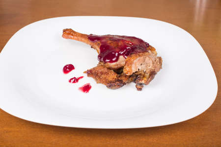 roasted duck leg with raspberry sauceの写真素材