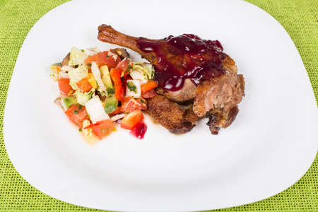 whole leg roasted duck with raspberry sauce and saladの写真素材