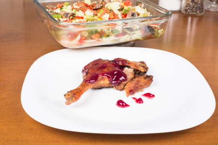 whole leg roasted duck with raspberry sauce and saladの写真素材
