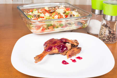 whole leg roasted duck with raspberry sauce and saladの写真素材